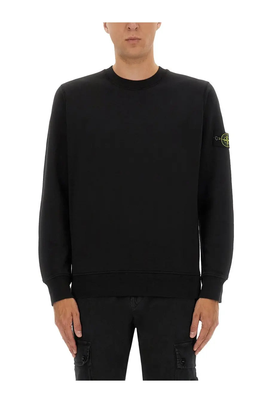 Stone Island men’s regular fit black crewneck sweatshirt with subtle yellow logo patch on left sleeve