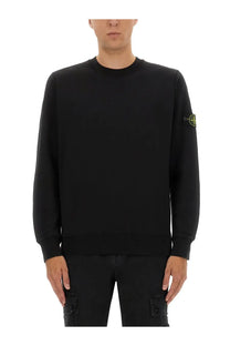 Stone Island men’s regular fit black crewneck sweatshirt with subtle yellow logo patch on left sleeve