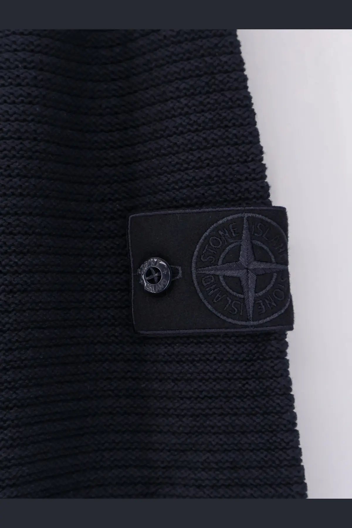 Black ribbed knit Stone Island men’s sweater with wool cashmere blend and matching black patch featuring compass logo