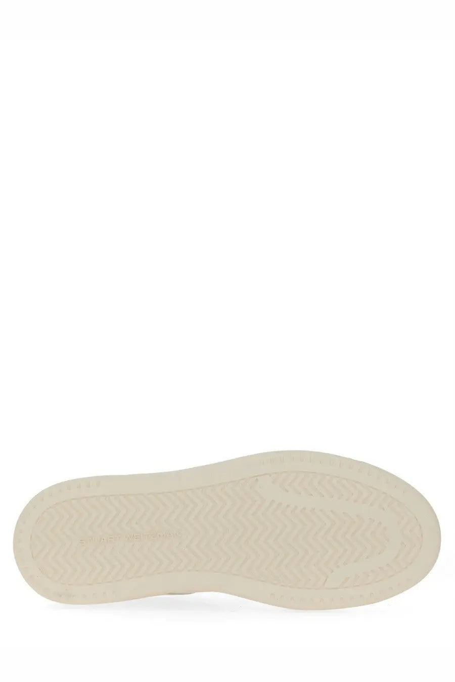Cream-colored rubber sole with subtle herringbone tread on stuart weitzman women’s white sneaker