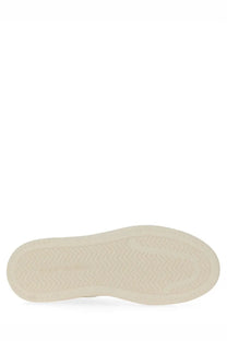 Cream-colored rubber sole with subtle herringbone tread on stuart weitzman women’s white sneaker