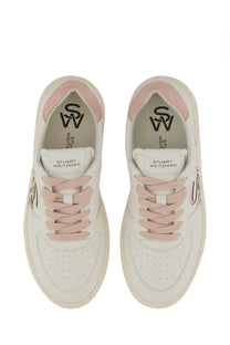 Stuart Weitzman women’s white leather sneakers with pink laces and accents featuring the logo on the insole