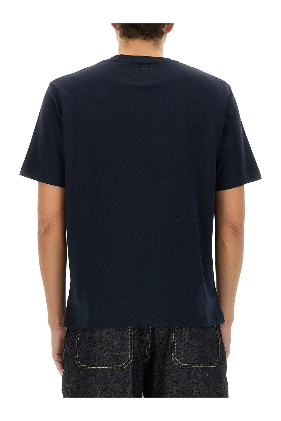 Studio Nicholson men’s jersey shirt in dark navy blue with short sleeves and a subtle brand tag at the neckline