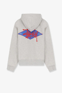 Back of a heather gray stussy men’s cotton blend sweatshirt featuring a bold red and blue diamond logo