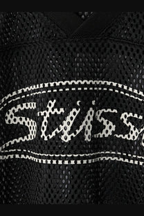 Stussy men’s black perforated nylon athletic jersey featuring a white stussy logo with dotted outline and stitched border