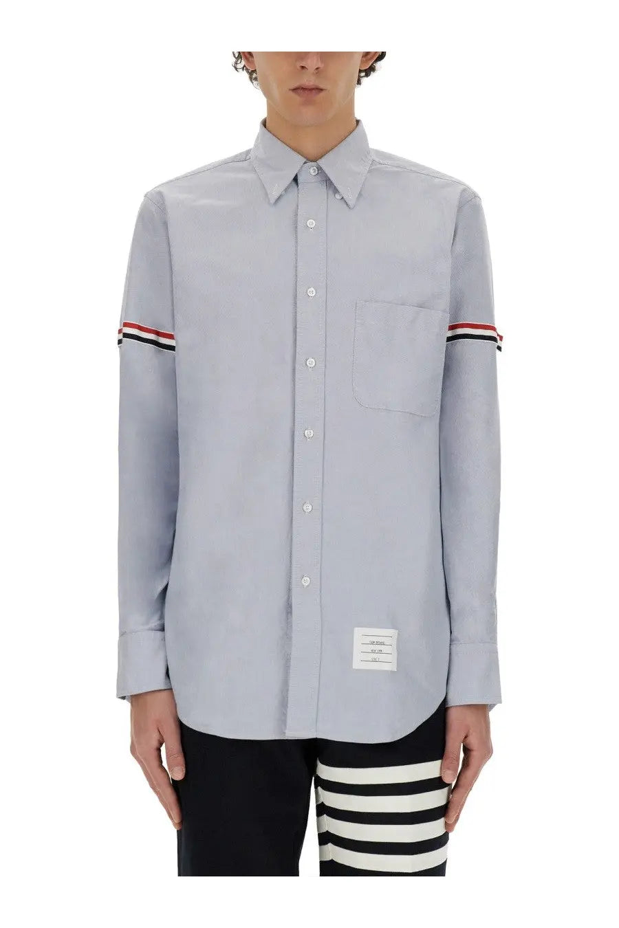 Thom Browne men’s classic light gray long-sleeved button-down shirt with red white and black striped cuffs and branded hem