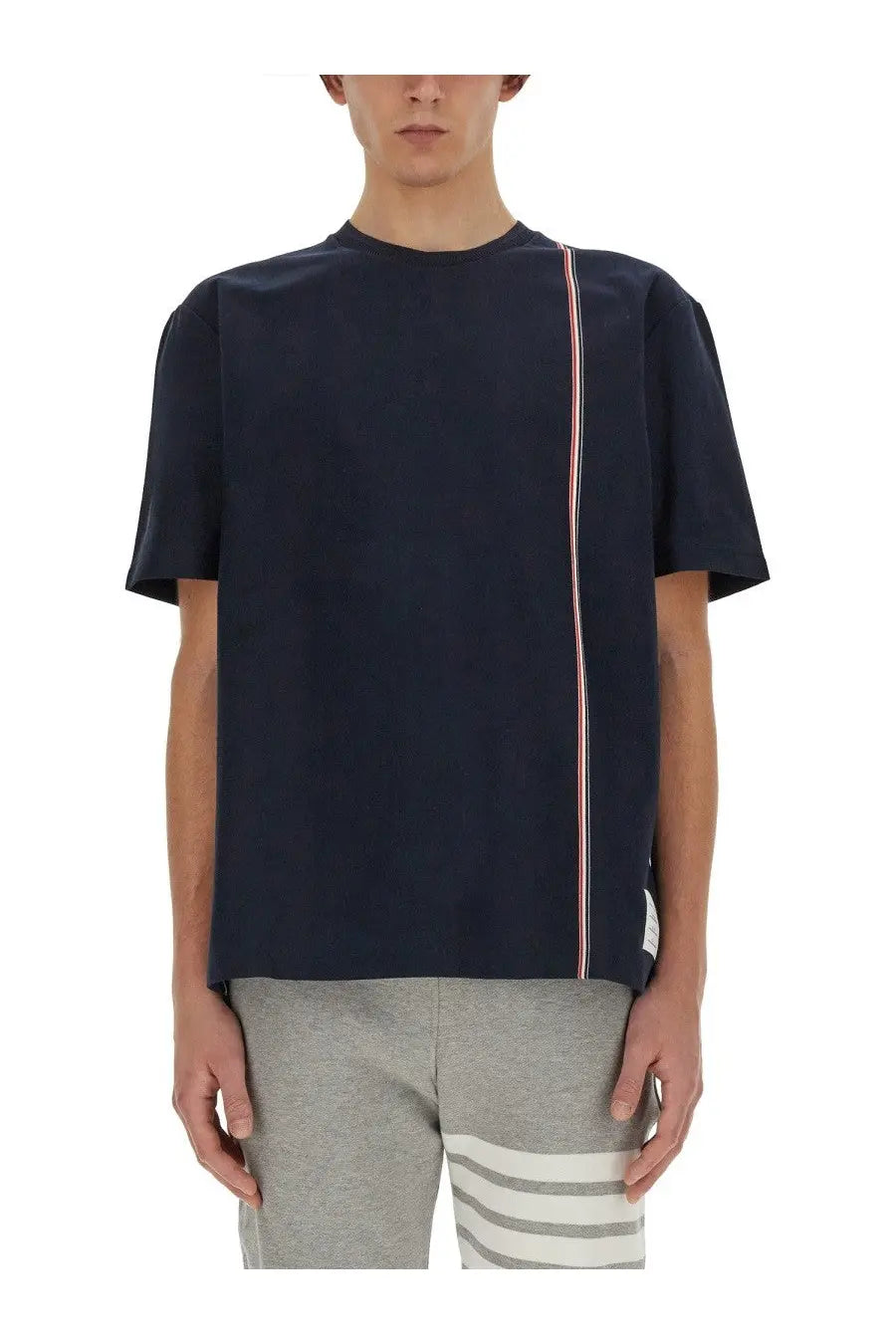 Thom Browne men’s dark navy blue jersey shirt with short sleeves and red white blue vertical stripe detail on the side