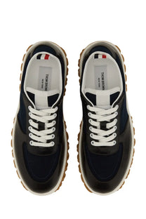 Thom Browne men’s trainer letterman blue sneakers in navy blue and black with white laces and textured rubber sole