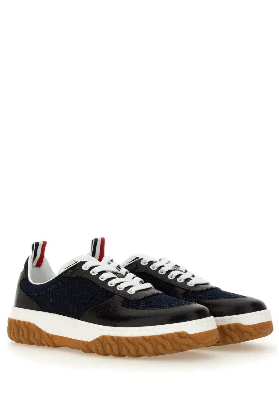 Thom Browne men’s trainer letterman blue navy and black low-top sneakers with white laces and gum rubber sole visible from back