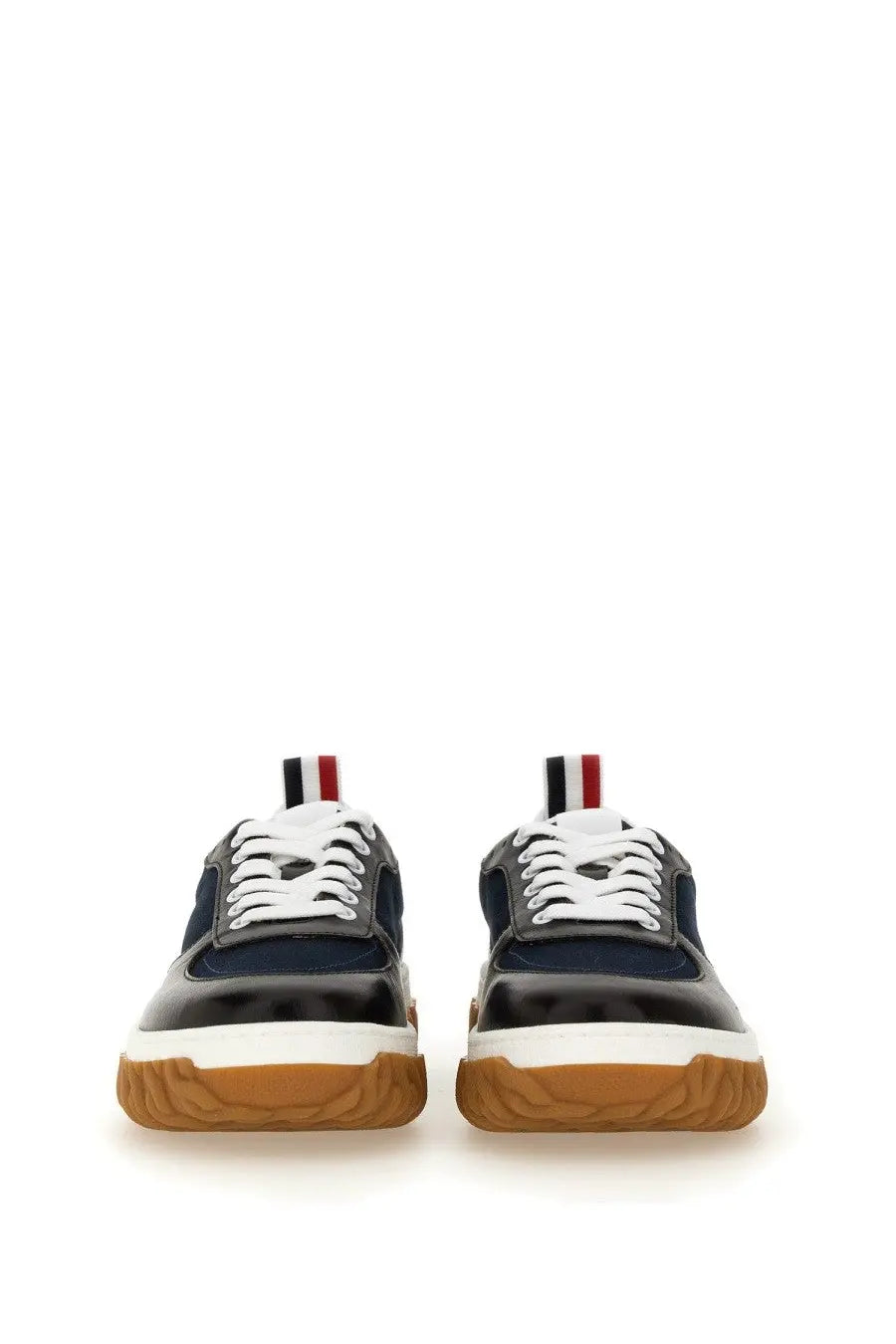 Thom browne men’s trainer letterman blue navy and black two-tone sneaker with white laces and gum rubber sole back view