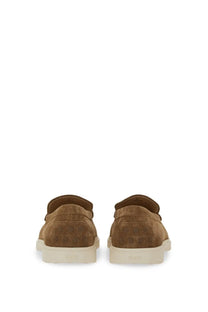 Tod’s men’s brown leather slipper loafer in tan suede with subtle embossed logo on heel and white rubber soles back view