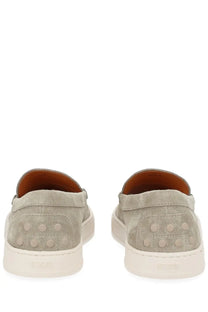 Tod’s men’s moccasin cassette beige gray suede slip-on sneakers with white rubber soles and circular heel studs back view