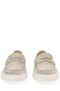 Beige suede Tods men’s moccasin cassette loafers with classic penny loafer design and white rubber soles