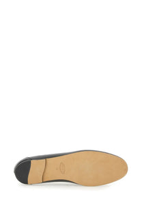 Back view of tods women’s black leather loafer with tan rubber sole and small logo on the heel