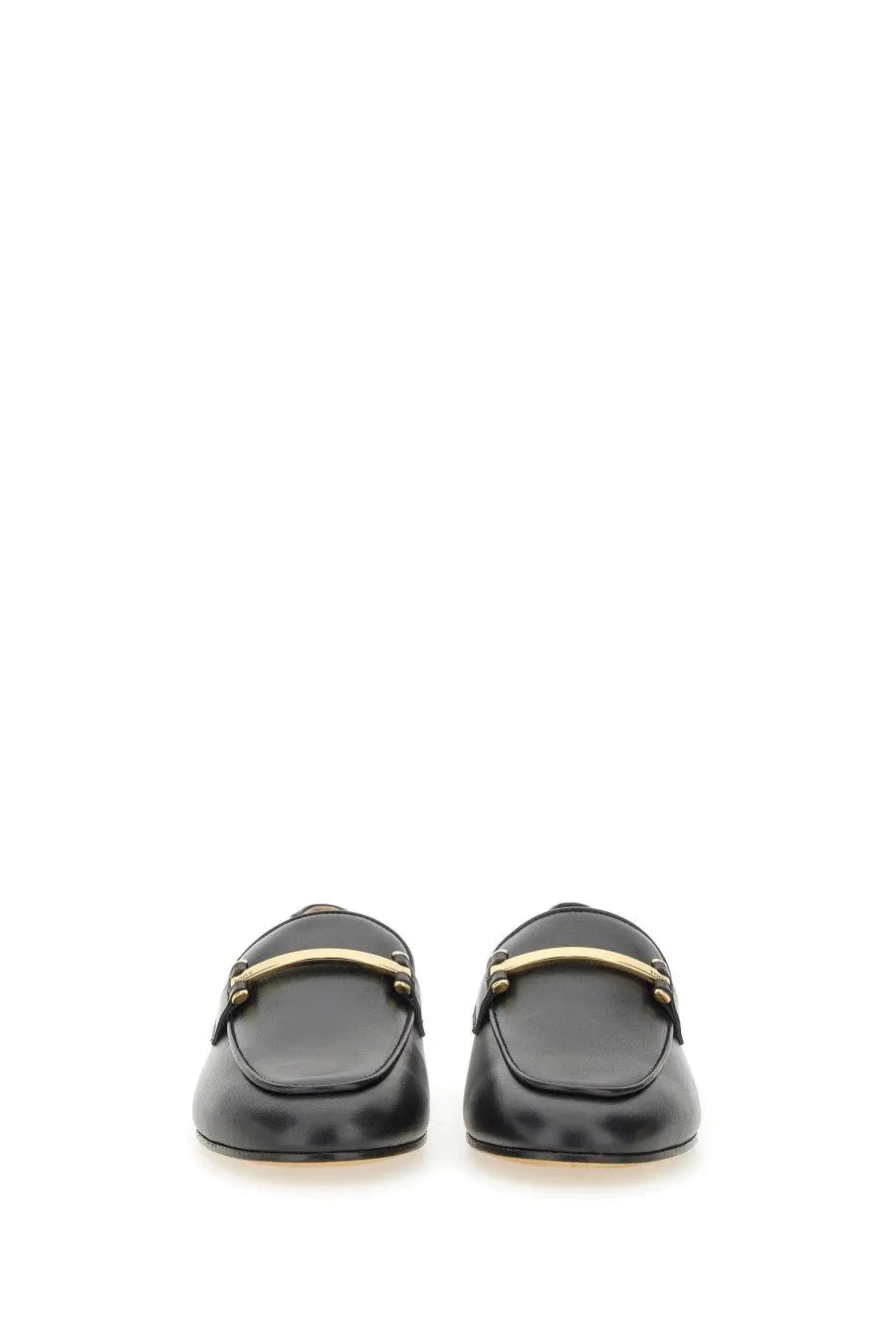 Tod’s women’s black leather loafers featuring a gold-tone bar across the top for stylish comfort