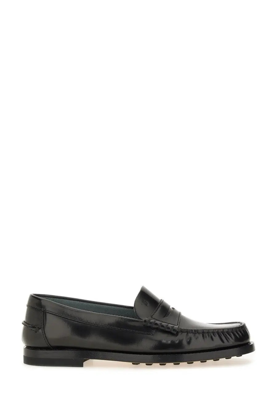 Tod’s women’s leather loafer in black patent leather with a glossy finish and distinctive lug sole