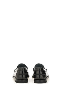 Tod’s women’s leather loafer black patent leather with sleek glossy finish and classic slip-on design