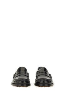 Tod’s women’s leather loafer in black patent leather with glossy finish and stitched detailing