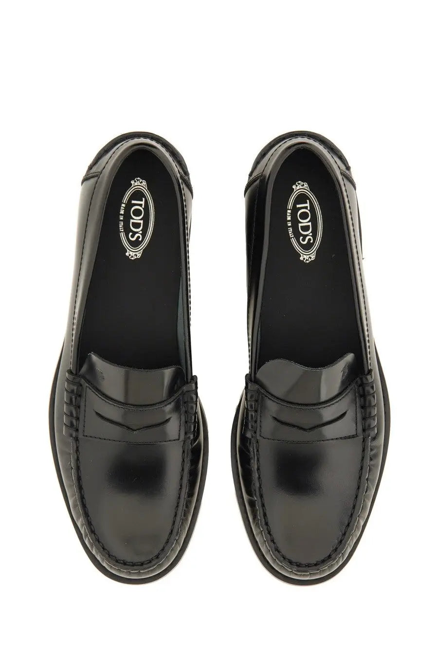 Tod’s women’s black leather loafer with glossy patent leather finish and classic penny loafer design