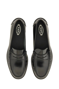 Tod’s women’s black leather loafer with glossy patent leather finish and classic penny loafer design