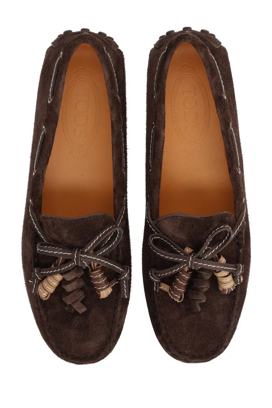 Tods women’s mocassino brown suede loafers with white stitching and decorative tassels in a classic design