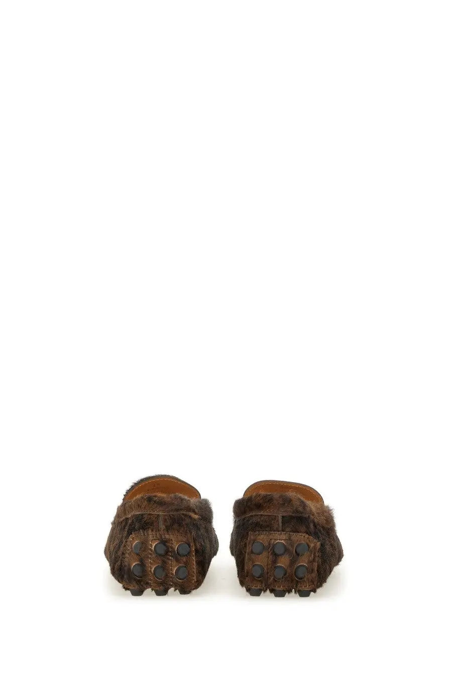 Tod’s women’s moccasin gommino macro black featuring brown fur-lined loafers with textured dark brown rubber sole and circular studs