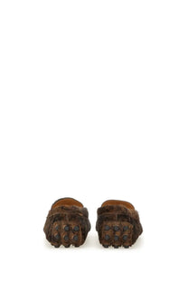 Tod’s women’s moccasin gommino macro black featuring brown fur-lined loafers with textured dark brown rubber sole and circular studs