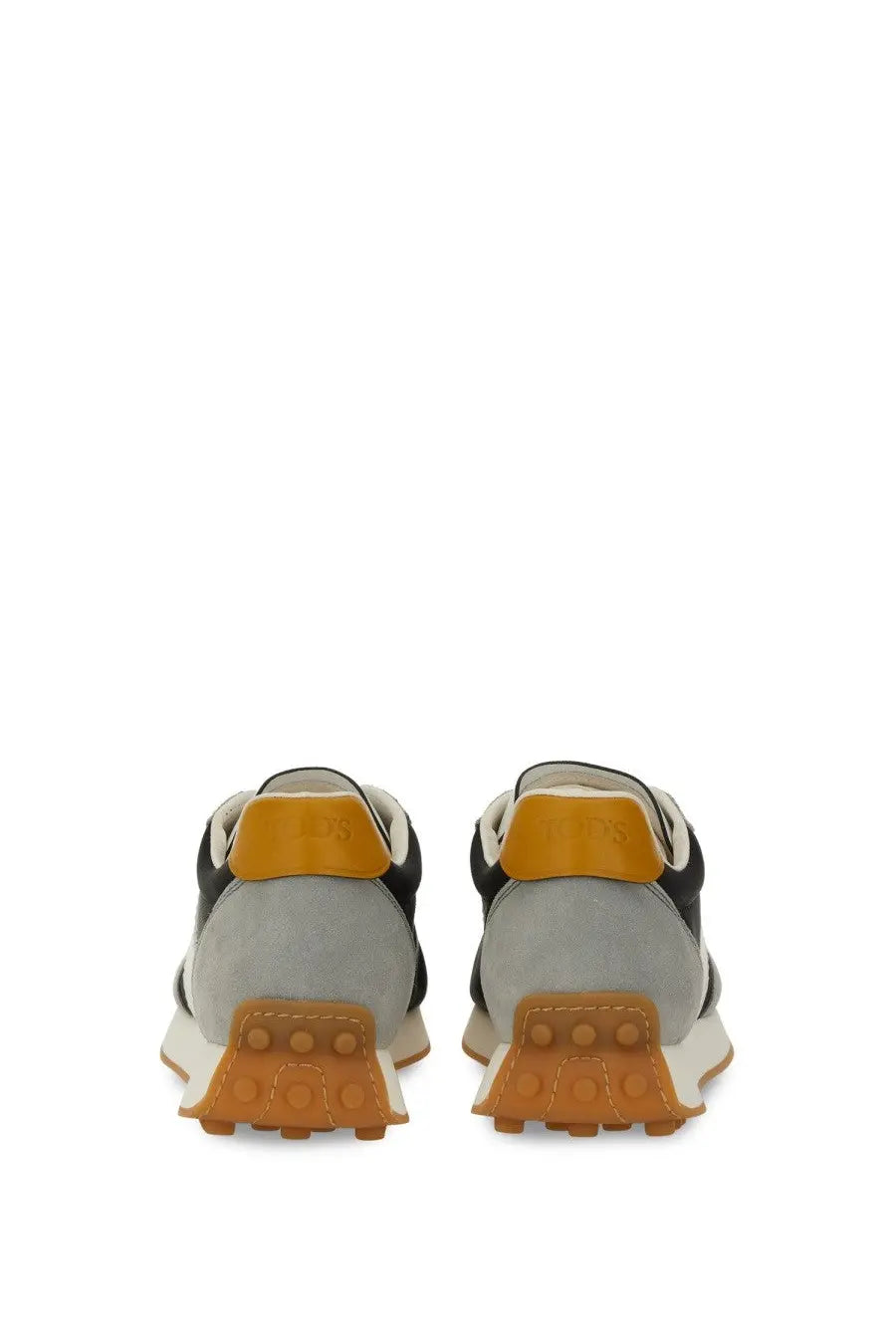 Tod’s women’s vintage sneaker grey in black and gray suede with orange rubber heel tab and sole shown from the back