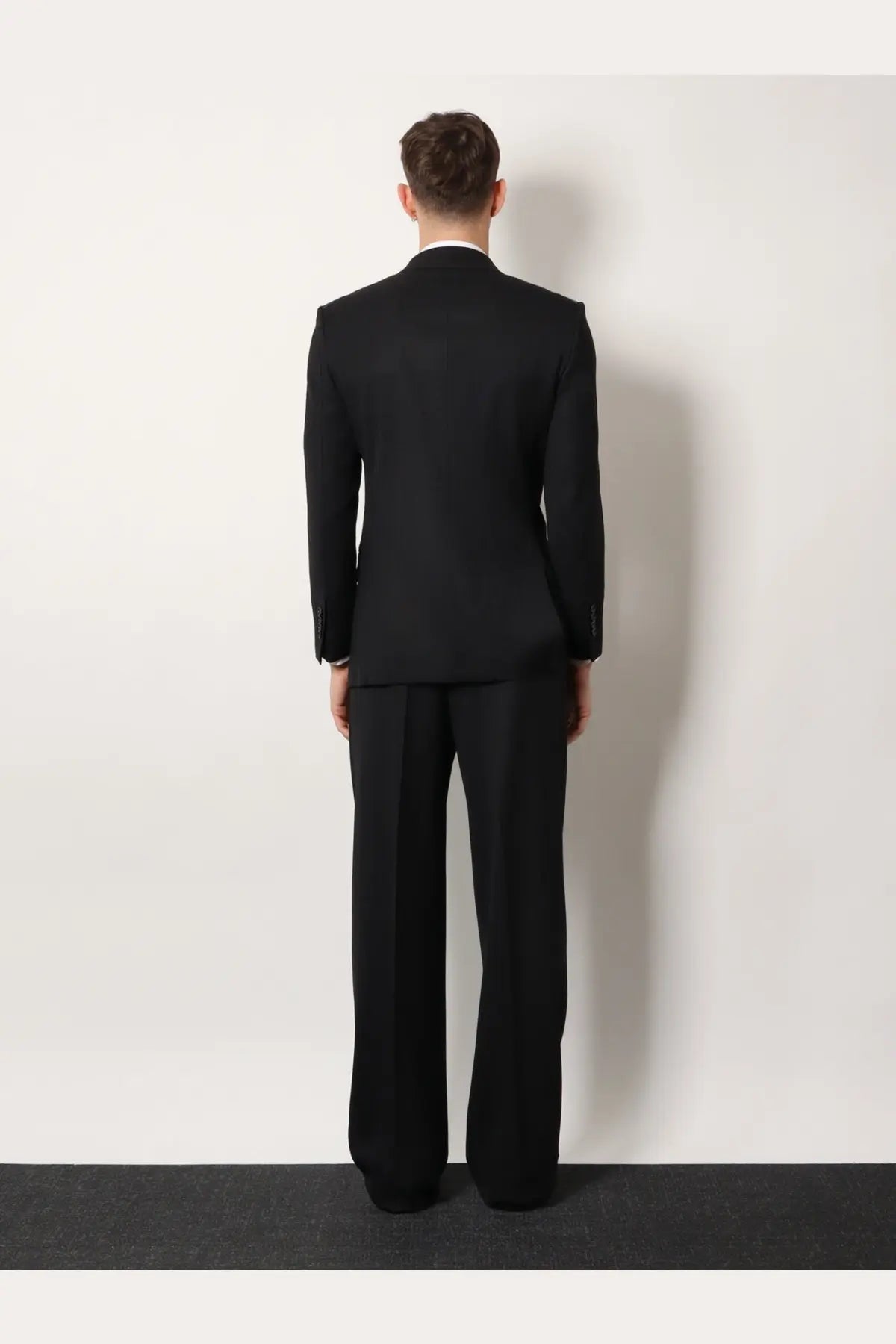 Black tailored wool suit featuring a structured jacket and matching trousers from tom ford men’s atticus collection