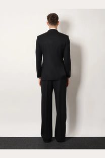 Black tailored wool suit featuring a structured jacket and matching trousers from tom ford men’s atticus collection