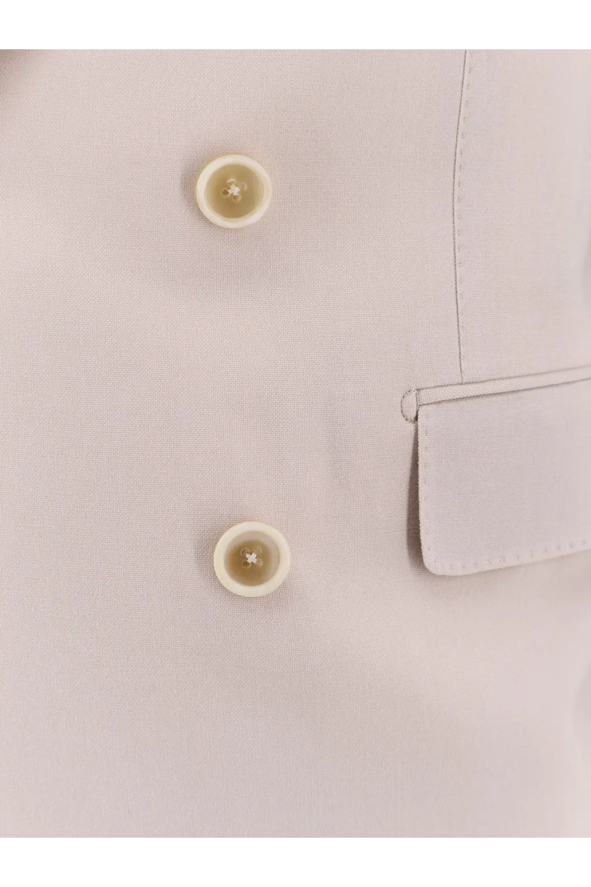 Cream-colored round buttons with subtle sheen and cross-shaped indentations on tom ford men’s cashmere silk blazer white