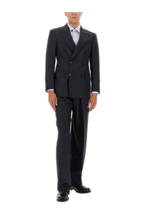 Dark navy double-breasted suit with tailored fit and subtle texture paired with tom ford men’s pinstripe blue pants