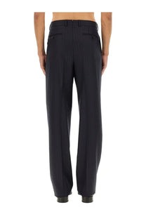 Tom Ford men’s pinstripe pants blue made of dark navy wool with a tailored fit and subtle back pleats shown from the back