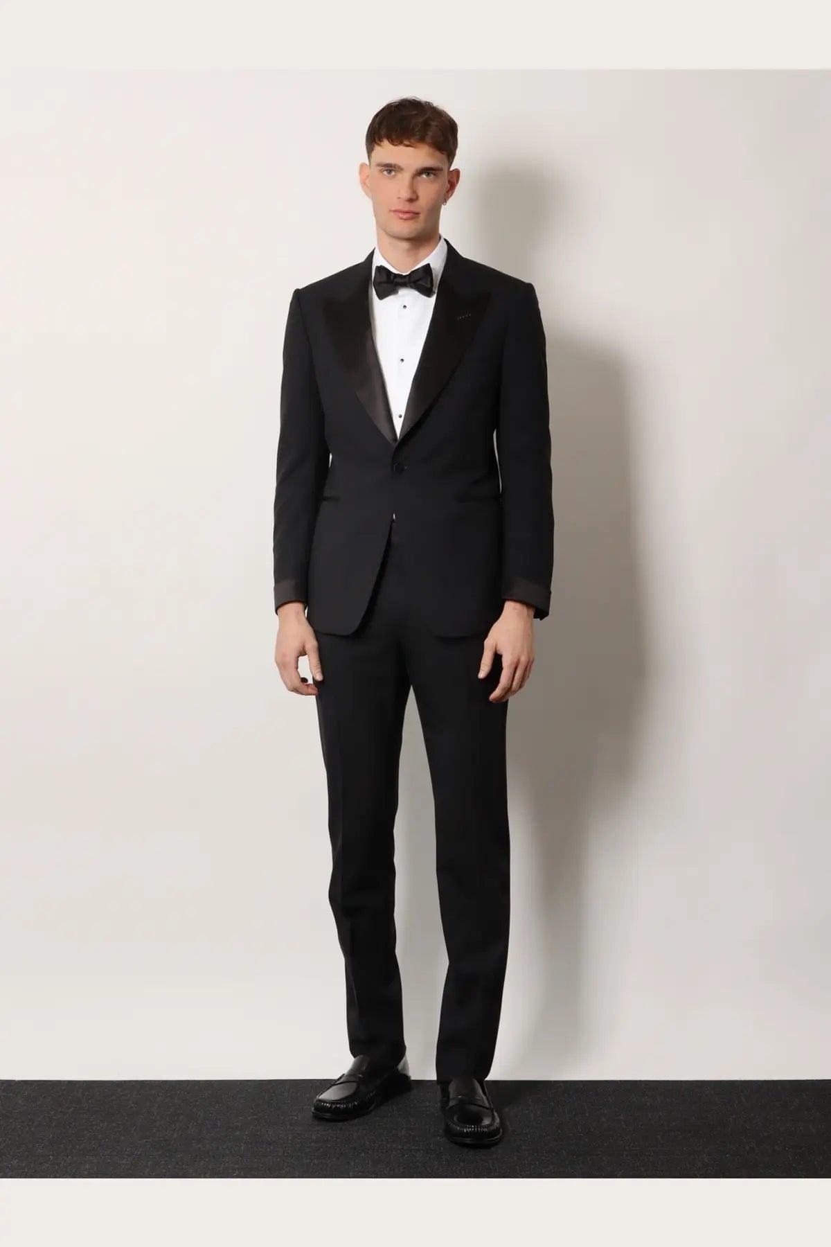 Tom Ford men’s Shelton wool tuxedo in black featuring satin lapels and matching trousers