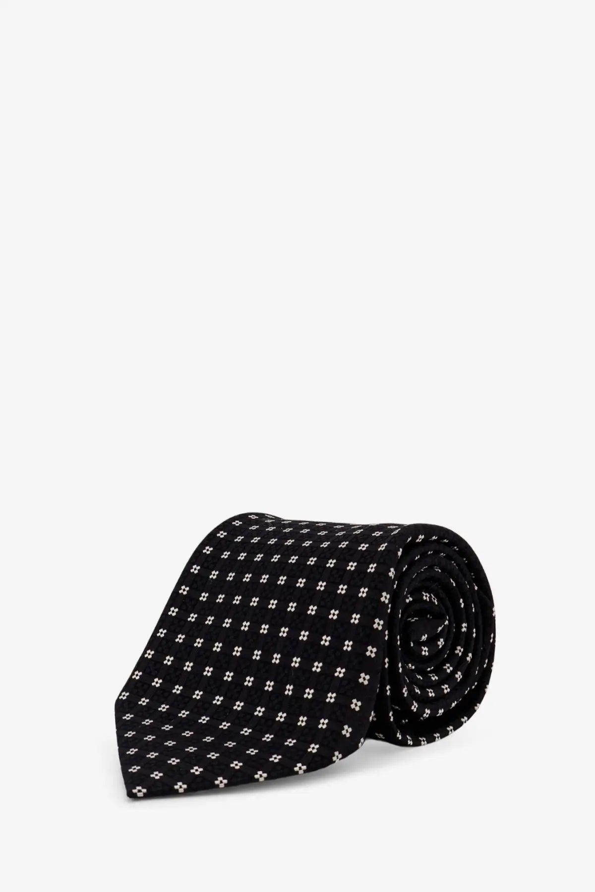 Black silk tie by tom ford with a subtle white quatrefoil pattern for men formal wear