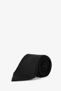 Tom ford men’s black silk tie with textured fabric rolled neatly for display