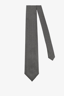 Tom Ford men’s silk tie silver featuring a classic black and white houndstooth pattern with a sharp pointed tip