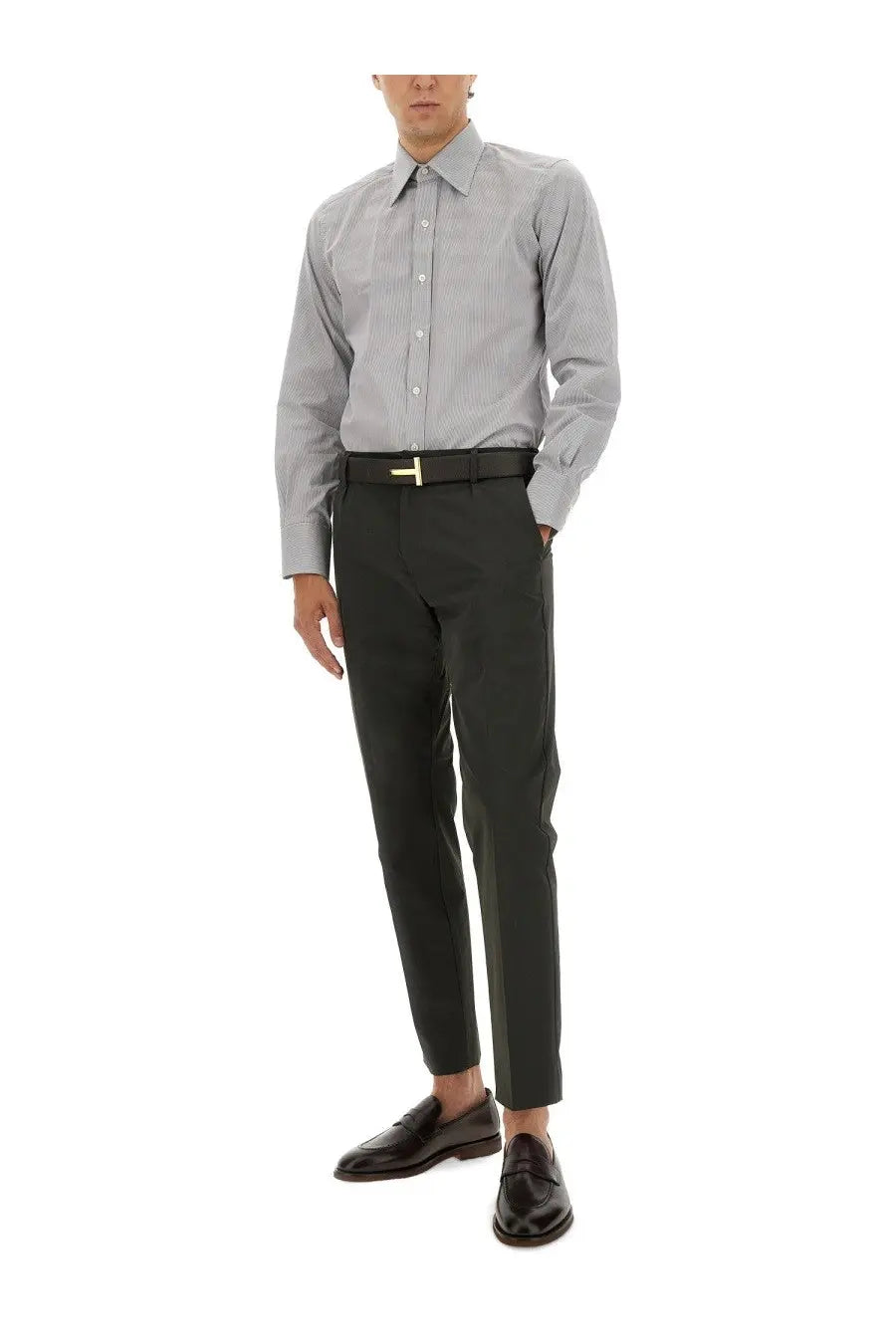 A man wearing a tom ford men’s slim fit grey pinstripe dress shirt with black trousers and a dark belt with gold t buckle