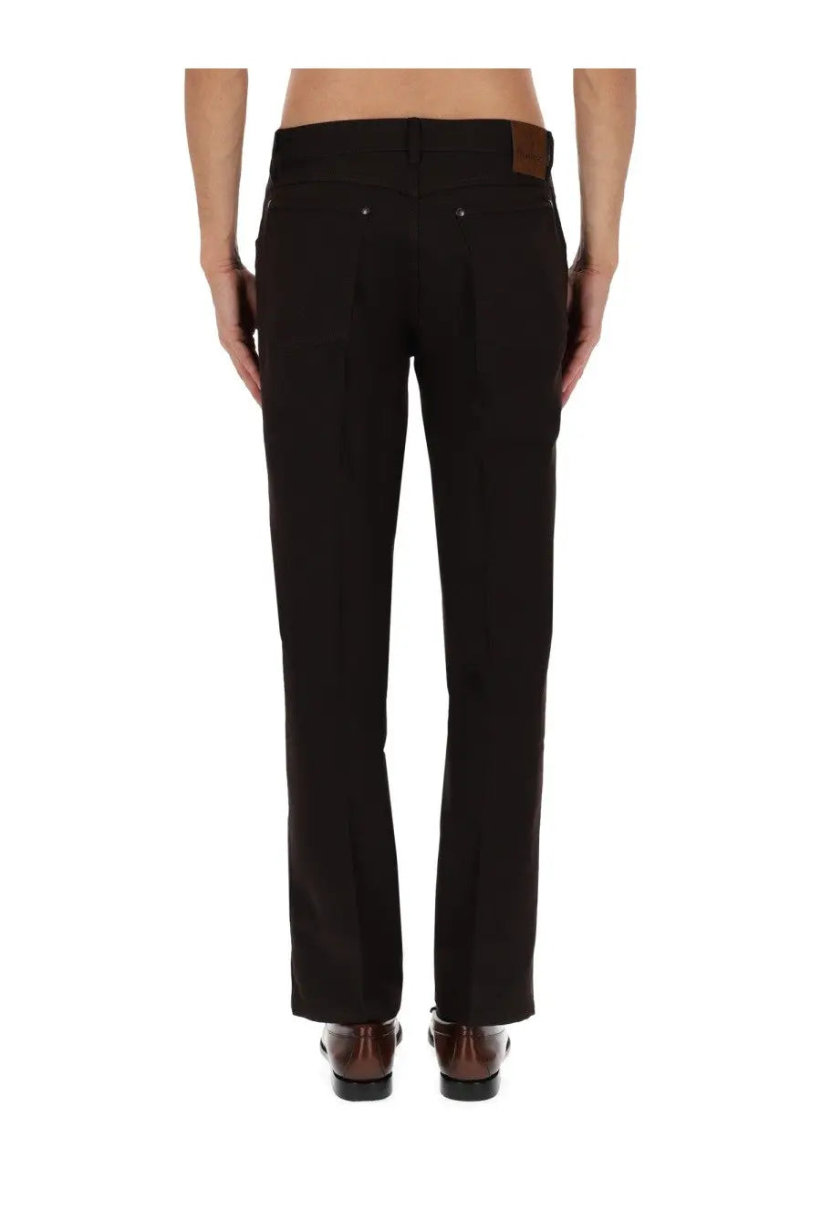 Black tailored wool trousers with brown leather patch at waistband tom ford men’s wool pants brown back view