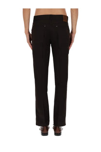 Black tailored wool trousers with brown leather patch at waistband tom ford men’s wool pants brown back view