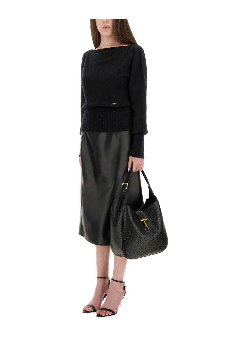 Black leather tote bag with gold-tone hardware and t-shaped clasp paired with tom ford women’s black boat neck sweater