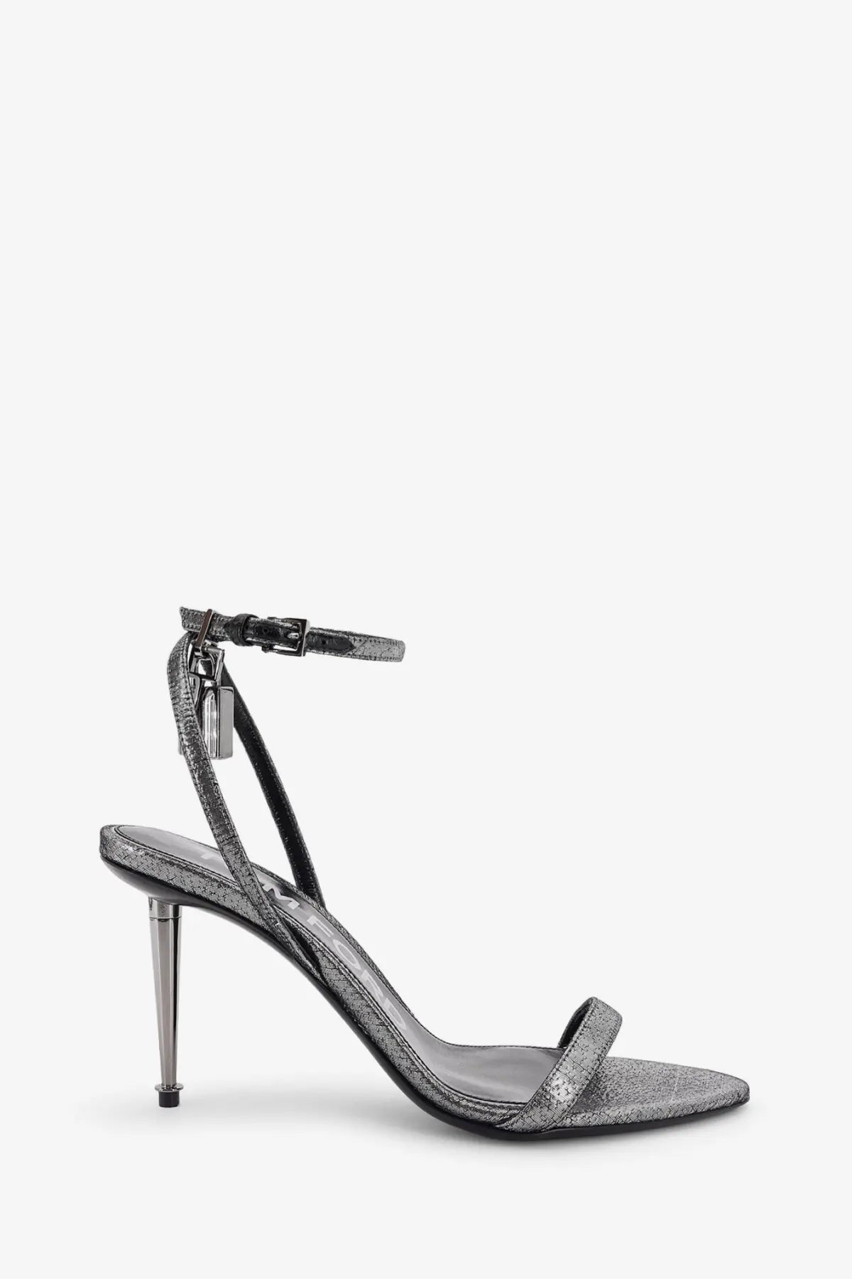 Tom Ford women’s laminated heeled sandals in silver with glittery ankle strap, slender metallic heel, and black leather accents