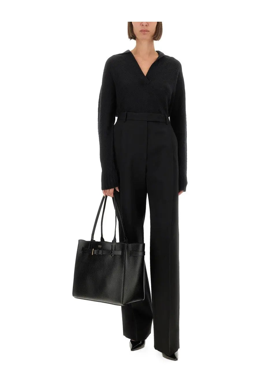 Tom ford women’s sharp wool pants black paired with a black leather tote bag featuring a structured shape and metallic clasp