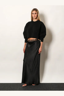 Black satin maxi skirt with sleek flowing drape and subtle sheen paired with tom ford women’s wool and cashmere sweater black