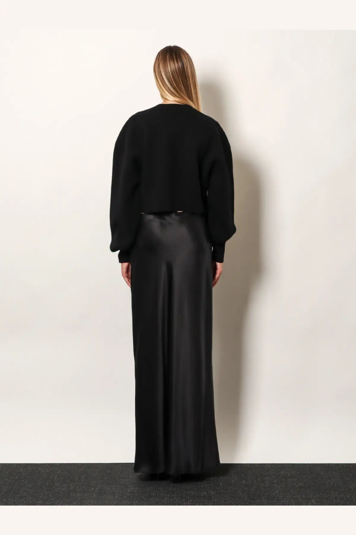 Black satin wide-leg trousers with sleek flowing drape paired with tom ford women’s wool and cashmere sweater black