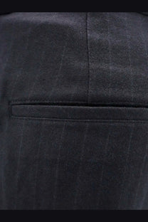 Dark charcoal pinstripe wool trousers with subtle textured weave and tailored seams for a sleek fit