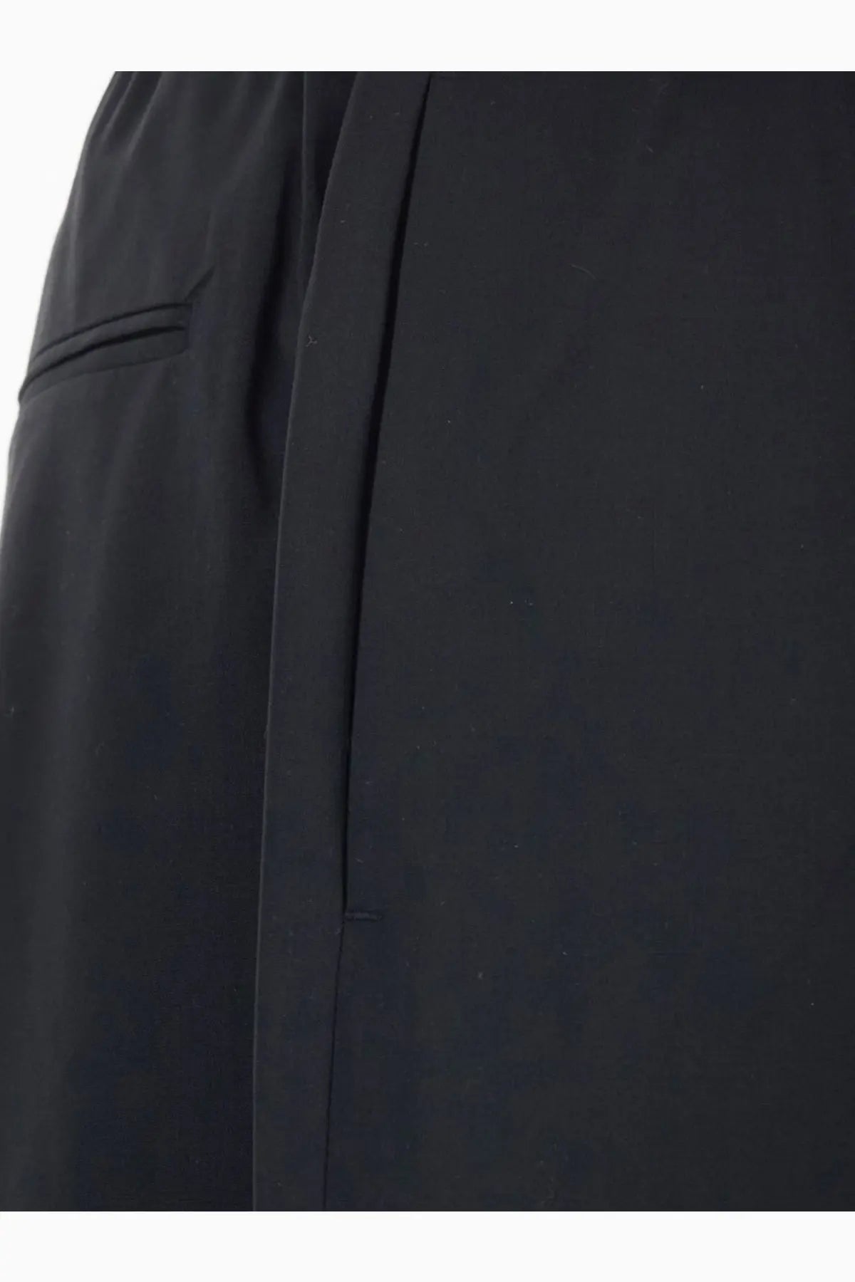 Black tailored Tonywack men’s wool blend trousers with sleek minimalist design and subtle pleating along side seam