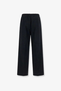 Black wide-leg wool blend trousers with elastic waistband and subtle back pocket showing the back side