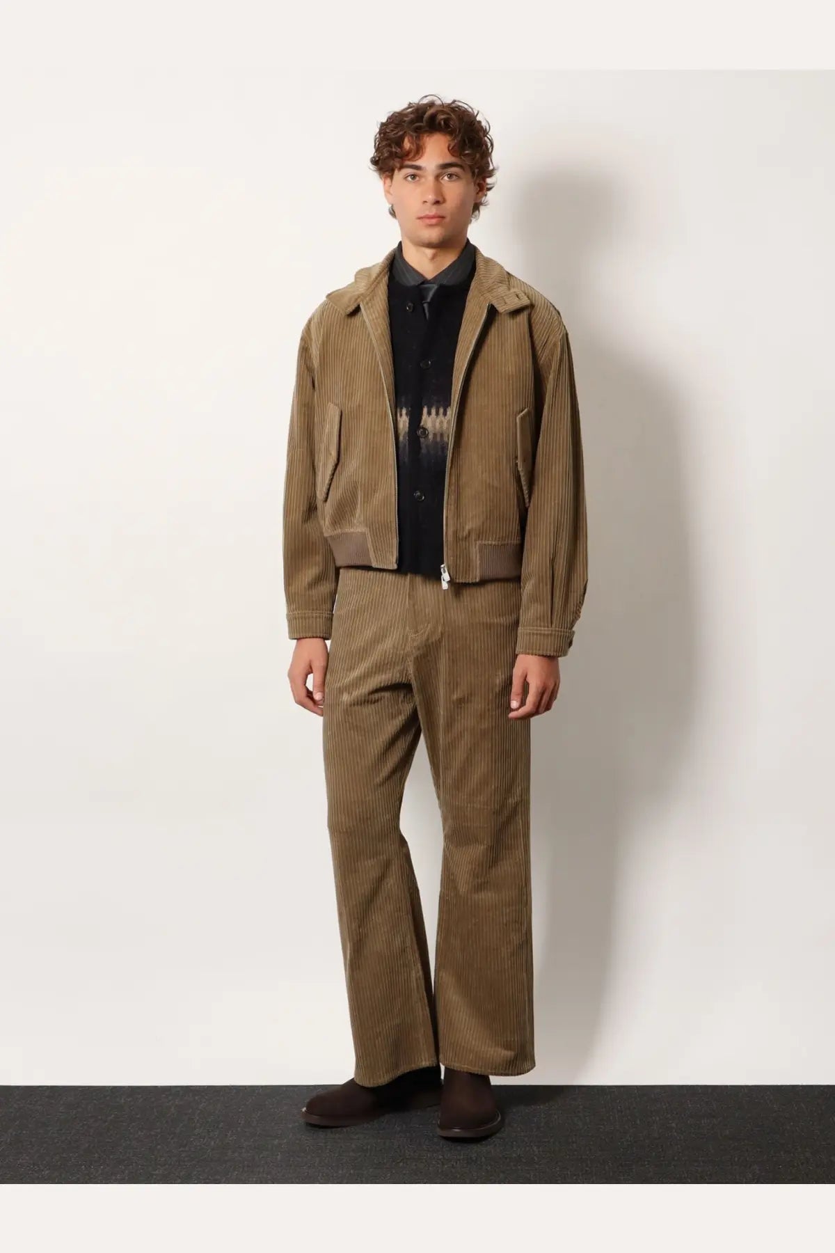 Brown corduroy jacket with vertical stripes and matching trousers paired with tonywack unisex jacquard alpaca cardigan black