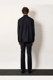 Black tailored wool blend suit with structured jacket and matching trousers paired with tonywack unisex blue striped shirt